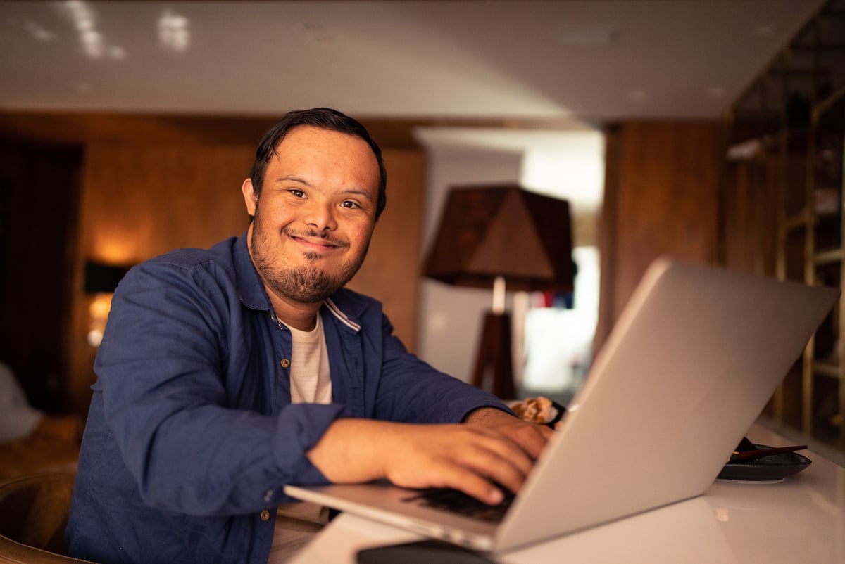 Man with Down Syndrome Using a Laptop